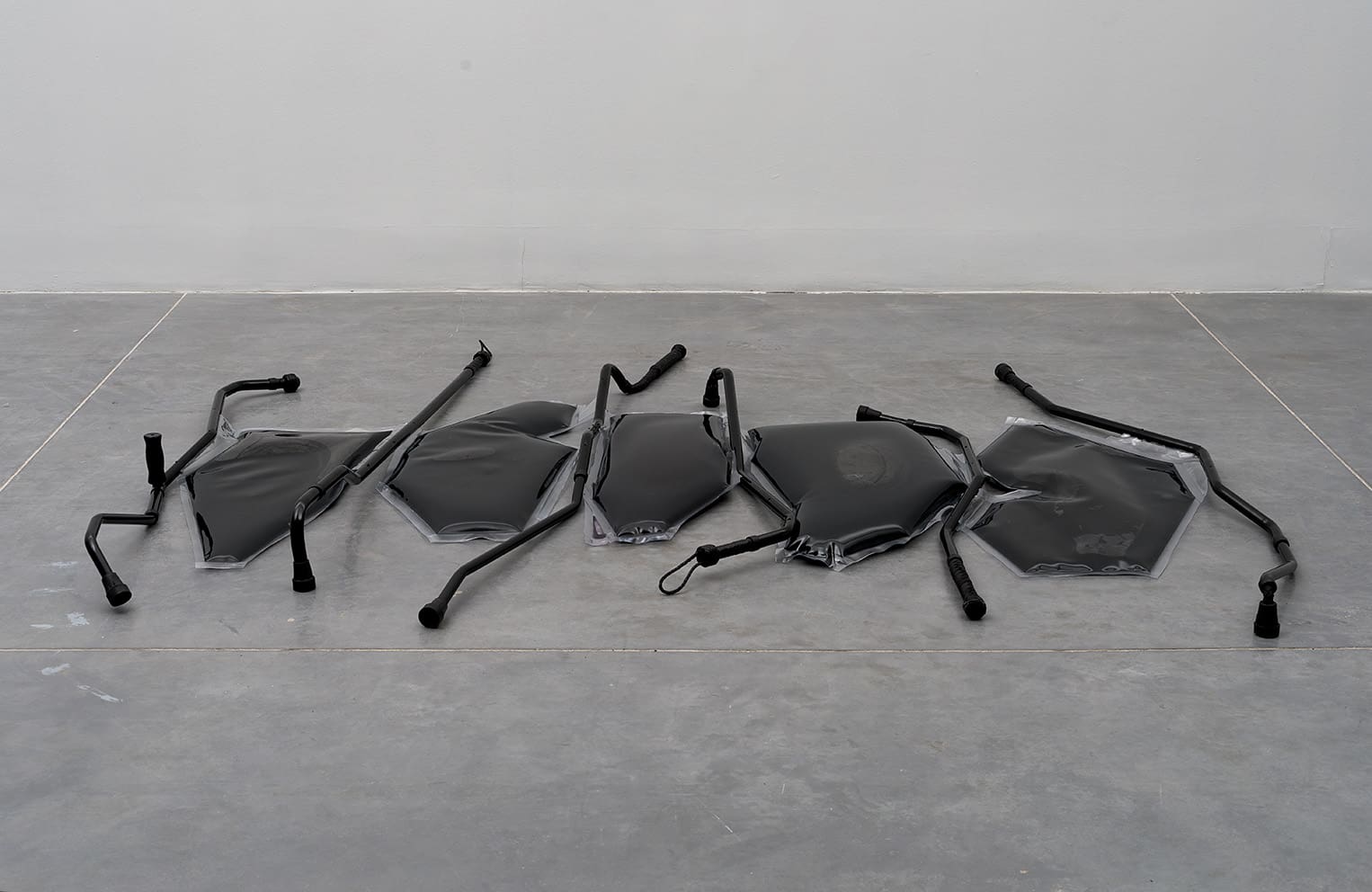 Untitled, 2018 (from the project: Unreasonable Doubt), crutches, whips, metals, PVC, ink, water, 246x200x13 cm