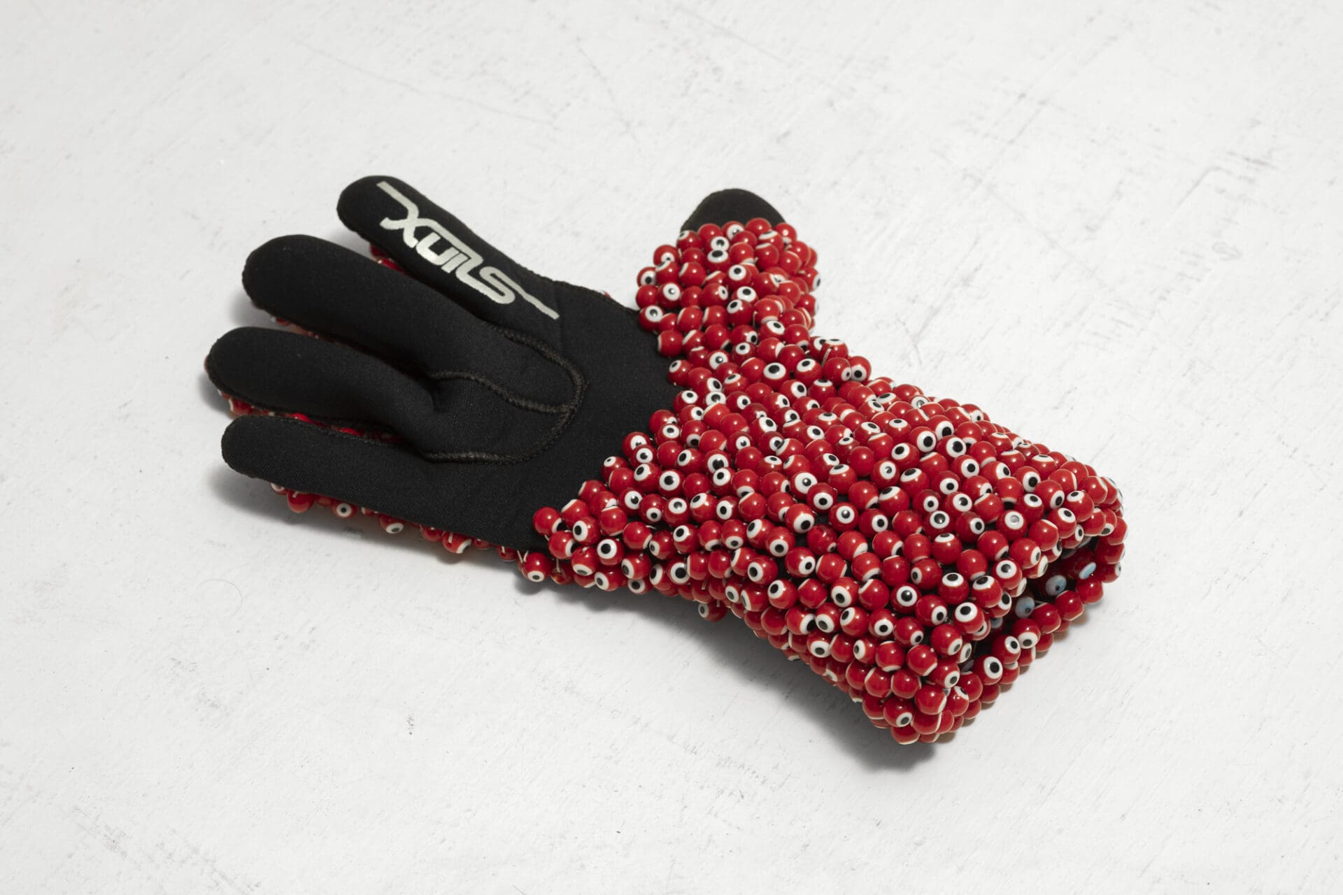 Left Hand, 2016-17, glove, evil eye beads, thread